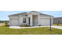 Beautiful single-Gathering home with a two-car garage, tidy landscaping, and a gray roof at 565 Sw 77Th Cir, Ocala, FL 34474