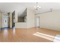Bright and airy living room featuring hardwood floors and natural light, adjacent to dining area at 8183 Westmont Terrace Dr, Lakeland, FL 33810