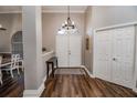 Bright entryway with hardwood floors, double doors, and a console table at 111 Arbor Way, Auburndale, FL 33823