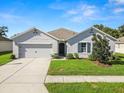 Move-in ready one-story home with a 2-car garage and attractive landscaping at 1655 Laurel Oaks Dr, Bartow, FL 33830