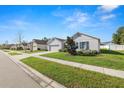 Enticing street view of a charming house with a lush lawn and two-car garage at 1655 Laurel Oaks Dr, Bartow, FL 33830