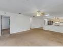 Bright living room with carpet, ceiling fan and open concept to kitchen at 1704 Pineberry Ct, Lakeland, FL 33803