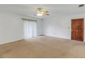 Spacious living room with carpet, ceiling fan and sliding glass doors at 1704 Pineberry Ct, Lakeland, FL 33803