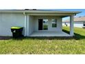 Covered patio with sliding glass doors at 2300 Crossandra St, Mascotte, FL 34753