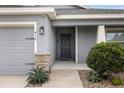 Modern front entry with gray door and stone accents at 416 Monticelli Dr, Haines City, FL 33844