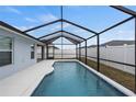 Inviting screened-in pool with a partially covered patio at 416 Monticelli Dr, Haines City, FL 33844