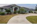 House exterior showcasing a curved driveway and landscaping at 5545 Harrells Nursery Rd, Lakeland, FL 33812
