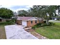 Brick home with attached garage and landscaped yard at 7405 Havenwood Dr, Lakeland, FL 33810