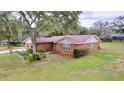Brick house with a large yard and driveway at 7405 Havenwood Dr, Lakeland, FL 33810