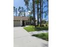 House with driveway and landscaping, located on a tree-lined street at 8052 Sugar Pine Blvd, Lakeland, FL 33810