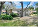 Two-story home with stone accents and a large, grassy yard at 1118 Cypress W Pt, Winter Haven, FL 33884
