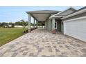 House exterior showcasing paver driveway and covered walkway at 161 Laynewade Rd, Polk City, FL 33868