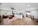 Open concept kitchen and living area with hardwood floors and island at 2226 Cordova N Cir, Lakeland, FL 33801