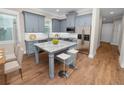 Modern kitchen with gray cabinets, granite island, and stainless steel appliances at 234 Laynewade Rd, Polk City, FL 33868