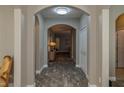 Bright and spacious entry hall with tile flooring and arched doorways at 252 Magneta Loop, Auburndale, FL 33823