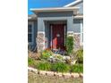 Inviting front entrance with red door and stone accents at 252 Magneta Loop, Auburndale, FL 33823