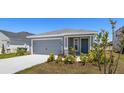 Single-story home with a gray exterior, two-car garage, and newly installed landscaping in the front yard at 3146 Laurel Oak Ln, Winter Haven, FL 33884