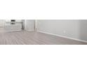 Open concept living room and kitchen area with bright walls and modern wood-look flooring at 3146 Laurel Oak Ln, Winter Haven, FL 33884