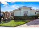 Light green house with a well-maintained lawn and shrubs at 3441 Grenville Dr, Winter Haven, FL 33884