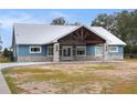 Ranch style home with metal roof and stone accents at 3960 Laurel Se Ave, Lakeland, FL 33812