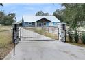 Blue house with a metal gate and stone pillars at 3960 Laurel Se Ave, Lakeland, FL 33812