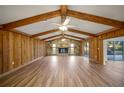 Spacious living room with a stone fireplace and wood beams at 410 N Tecumseh Ave, Fort Meade, FL 33841