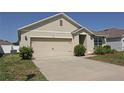 Inviting one-story home with an attached two-car garage and manicured landscaping at 433 Montego Bay Dr, Mulberry, FL 33860