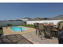 Enjoy outdoor living with a private pool, brick patio, and outdoor dining space at 433 Montego Bay Dr, Mulberry, FL 33860