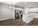 Bright, open kitchen featuring stainless steel appliances, a central island, and modern white cabinetry at 447 Ituna Cir, Winter Haven, FL 33881