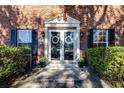 Elegant double front doors with white trim and black shutters at 5171 Deeson Pointe Ct, Lakeland, FL 33805
