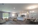 Open living space with kitchen, dining area, and hardwood floors at 557 Silver Course Run, Ocala, FL 34472