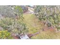 Aerial view shows the property's expansive backyard with a fenced area at 5576 Albert Williams Rd, Mulberry, FL 33860