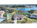 Single-story home with pool and lakefront view at 6004 Greenleaf Cir, Winter Haven, FL 33884