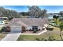 House with a large yard, driveway and lake view at 6004 Greenleaf Cir, Winter Haven, FL 33884