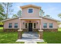Two-story house with stone accents and a landscaped lawn at 748 Mcclellan Rd, Frostproof, FL 33843