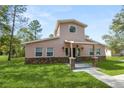 Two-story house with stone accents and a landscaped lawn at 748 Mcclellan Rd, Frostproof, FL 33843