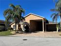 Attractive single-story residence with a large portico, side garage, and well-kept lawn at 1015 Crossroads Dr, Polk City, FL 33868