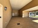 Attached garage with additional covered parking area at 1015 Crossroads Dr, Polk City, FL 33868