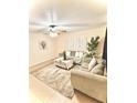 Bright living room featuring neutral-toned furniture and a cozy rug at 107 W 7Th St, Frostproof, FL 33843