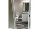 Updated bathroom with white vanity and granite countertop at 1108 Crestview Ave, Lakeland, FL 33805