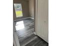 Bright bedroom featuring grey wood-look flooring at 1108 Crestview Ave, Lakeland, FL 33805