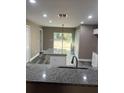 Modern kitchen with granite countertops and white cabinets at 1108 Crestview Ave, Lakeland, FL 33805