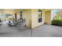 Farmhouse front porch with vintage wicker furniture at 1722 Broken Arrow N Trl, Lakeland, FL 33813