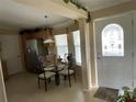 Cozy dining area featuring a round glass table and elegant decor upon entry at 2356 Peavine Cir # 1017, Lakeland, FL 33810