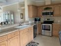 Well-equipped kitchen with stainless steel appliances, tile backsplash, and granite countertops at 2356 Peavine Cir # 1017, Lakeland, FL 33810