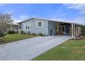 Mobile home with covered carport and inviting yellow door at 5079 Lodgewood Dr, Lakeland, FL 33810