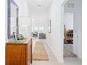 Bright hallway with tile flooring, leading to living areas and bedrooms at 636 Trotters Dr, Eagle Lake, FL 33839