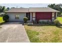 Ranch-style home with a gray exterior and mature landscaping at 6929 Farris Dr, Lakeland, FL 33811