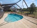 Relaxing kidney-shaped pool with a screened enclosure at 6929 Farris Dr, Lakeland, FL 33811