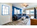 Living room with sectional sofa, coffee table, and wood flooring at 726 Erie Ct, Lakeland, FL 33803